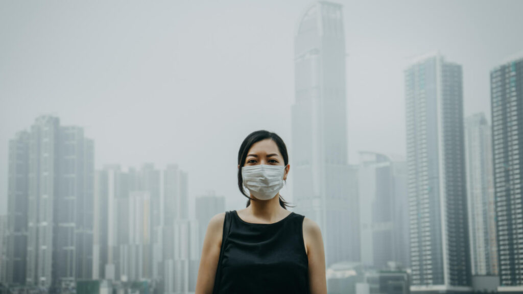 eco-anxiety-a-person-wearing-a-mask-with-city-pollution