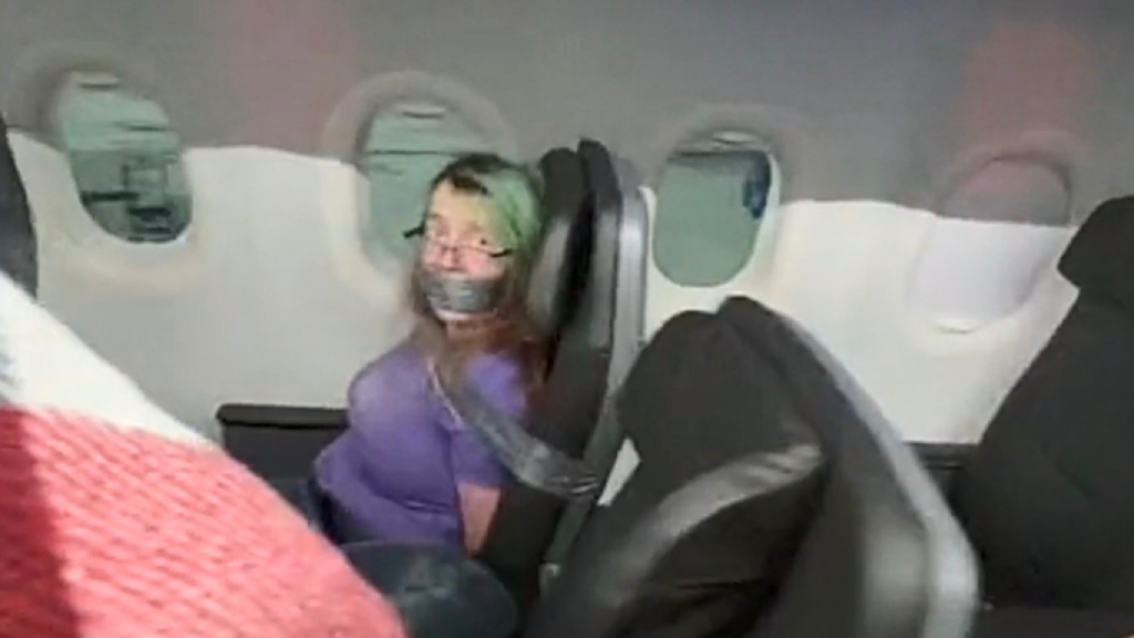 Watch: San Antonio woman duct-taped to American Airlines seat after trying to open door in flight sued for unpaid fine