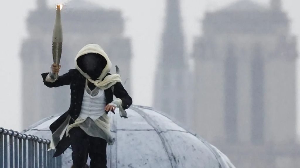 Breezy Explainer: Who was the masked torchbearer at the Paris Olympics opening ceremony?