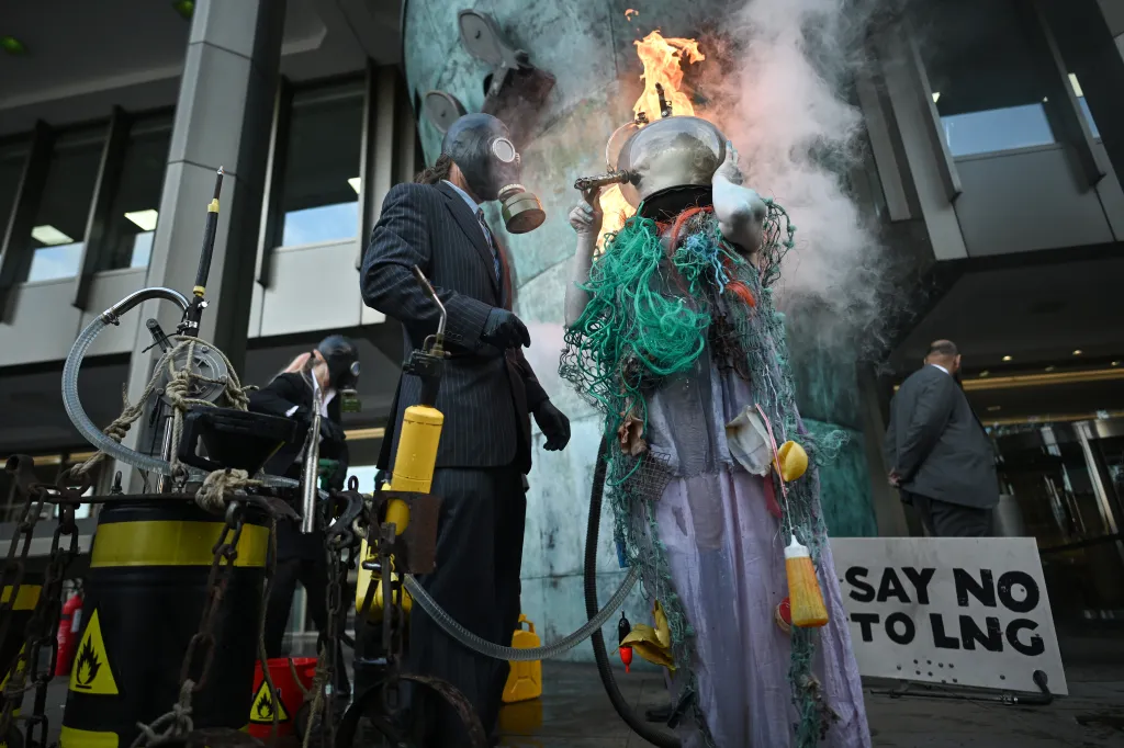 Climate activists ‘drown’ themselves in oil, gas, and flames in shocking protest against LNG in London